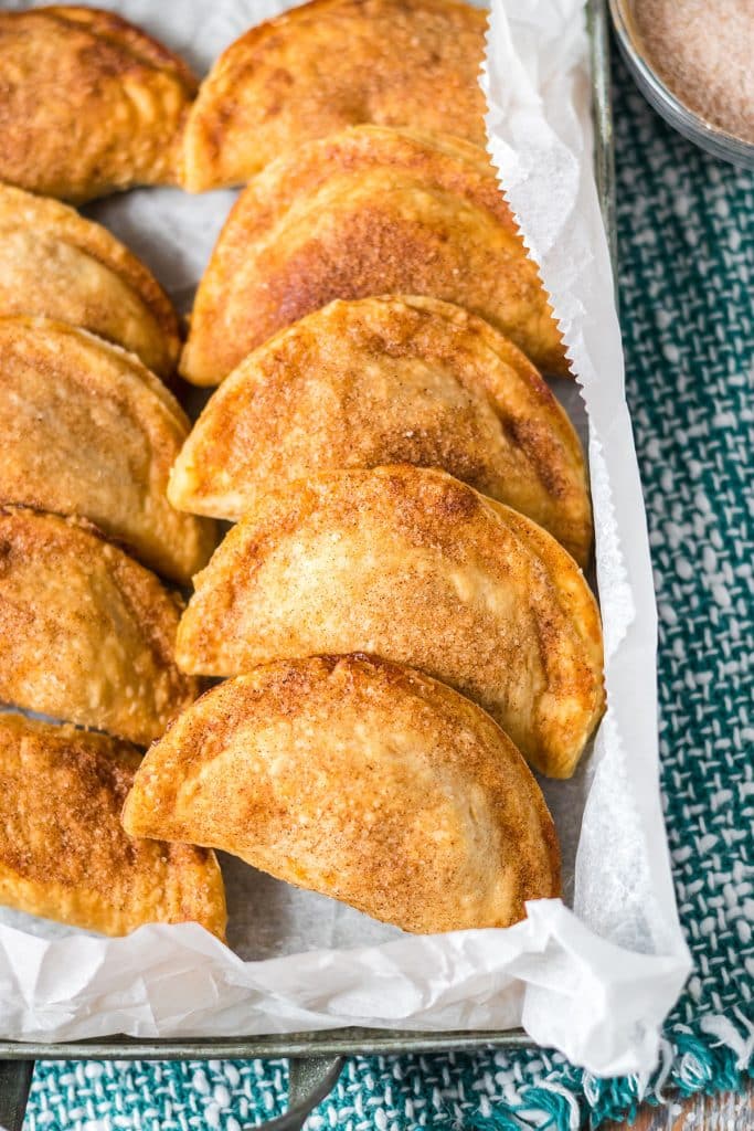 tray of empanadas topped with cinnamon & sugar.