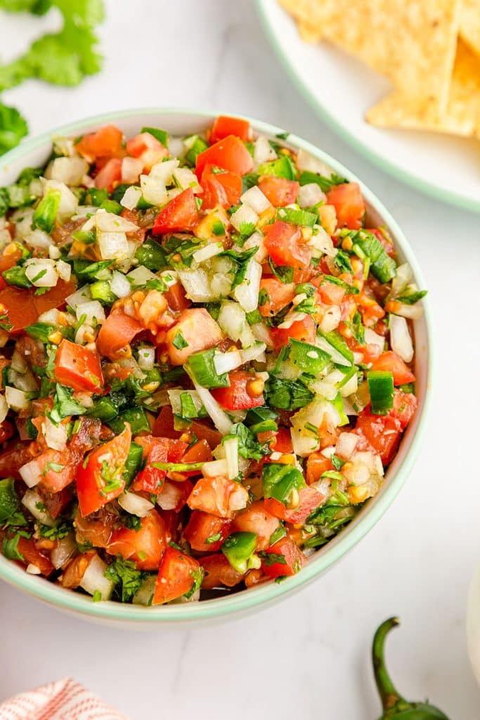 overhead shot of a bowl of pico de gallo salsa.