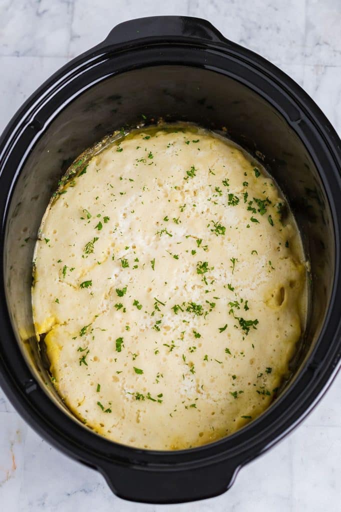 overhead shot of chicken cobbler in a crockpot.