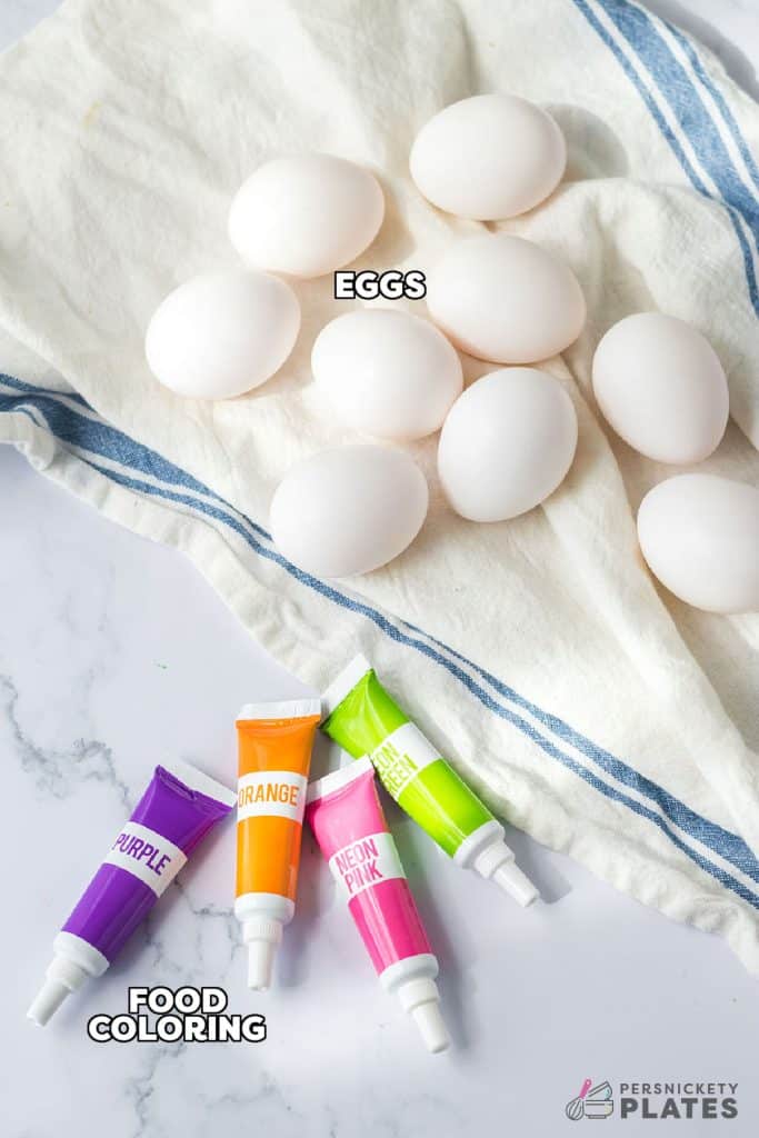 overhead shot of eggs and food coloring laid out to color eggs.