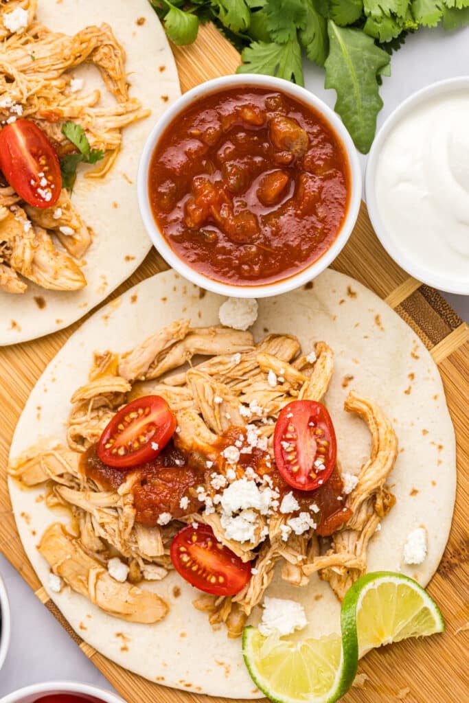 overhead shot of shredded chicken taco with toppings.