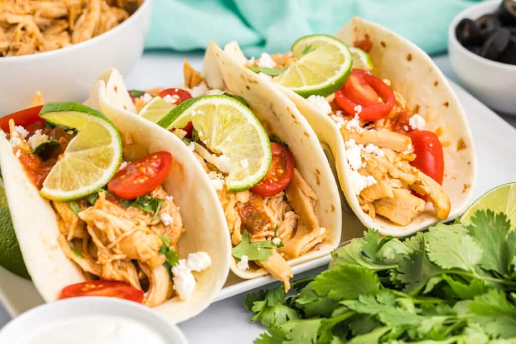 two honey lime chicken tacos on a platter.