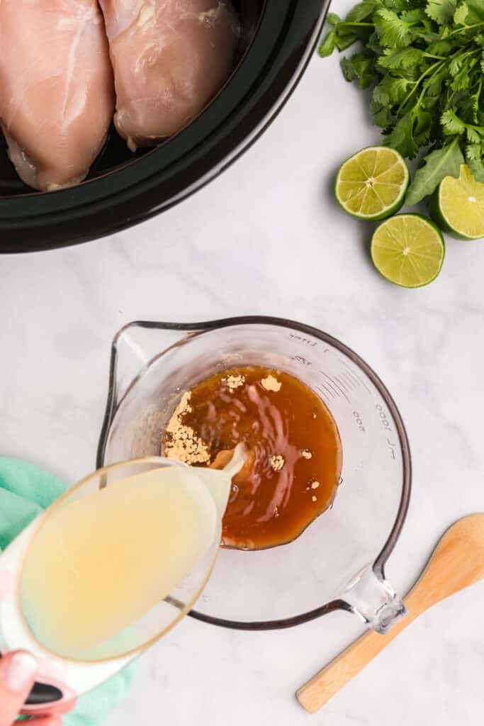 lime juice pouring into a honey lime marinade.