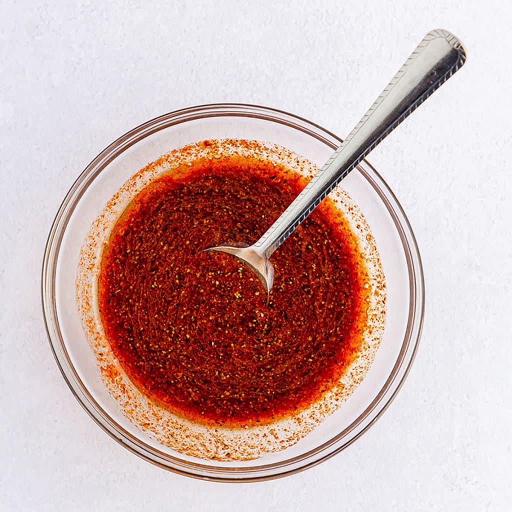 bowl of dressing with a fork stuck in it.