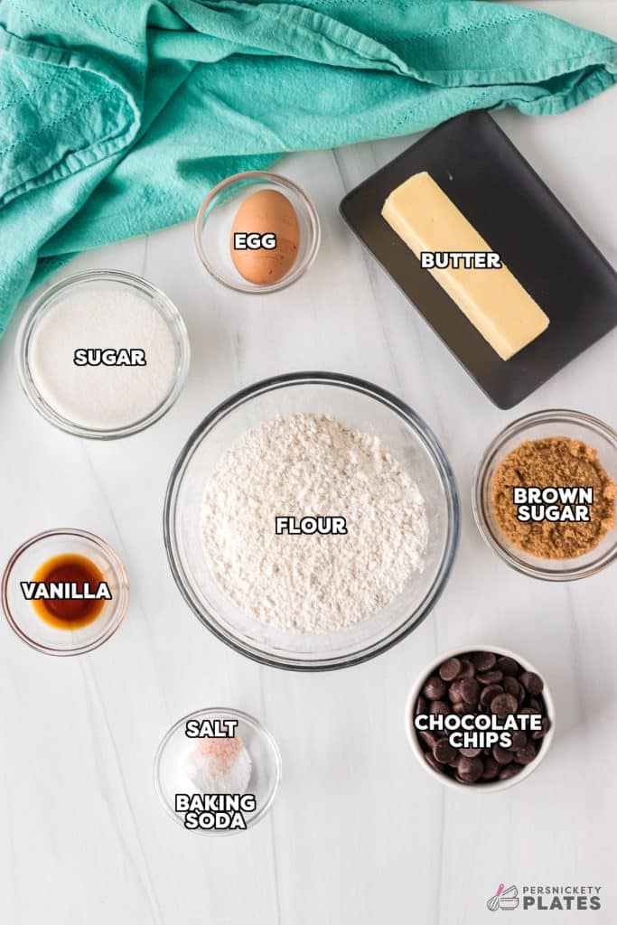 overhead shot of labeled ingredients laid out to make a chocolate chip cookie cake.