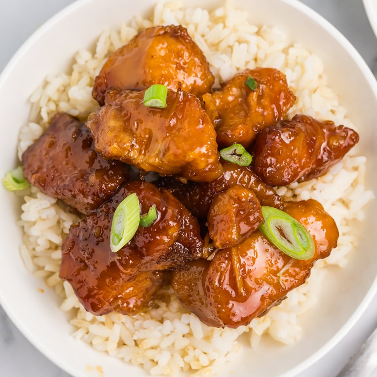 overhead shot of firecracker chicken over white rice.