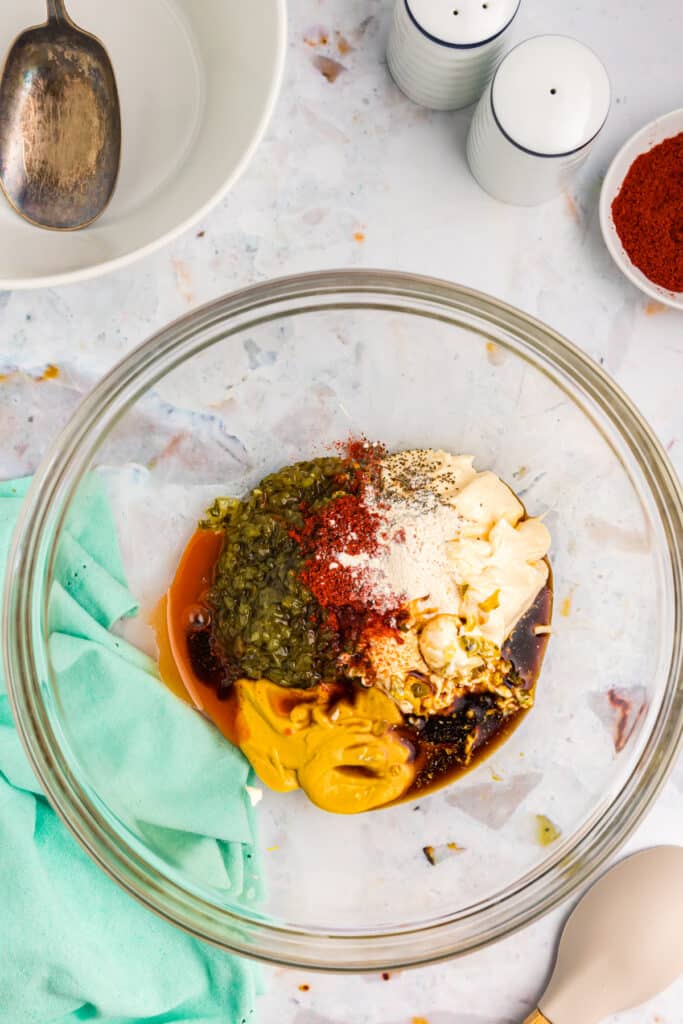 overhead shot of seasonings in a glass mixing bowl.