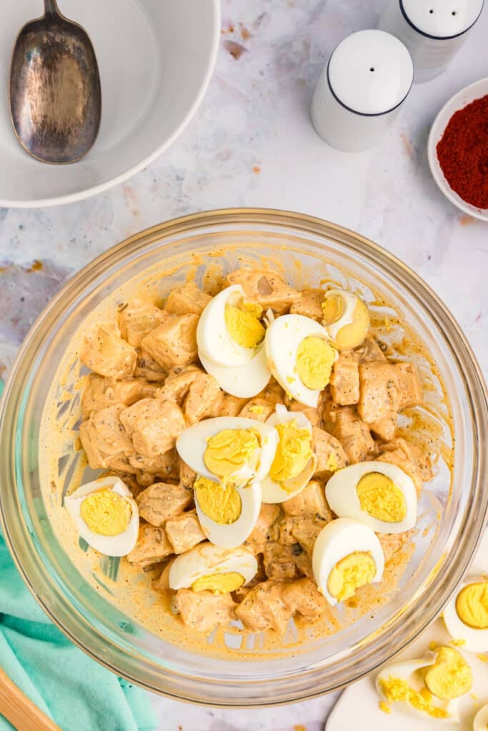 overhead shot of potato salad with sliced hard boiled eggs in a bowl.