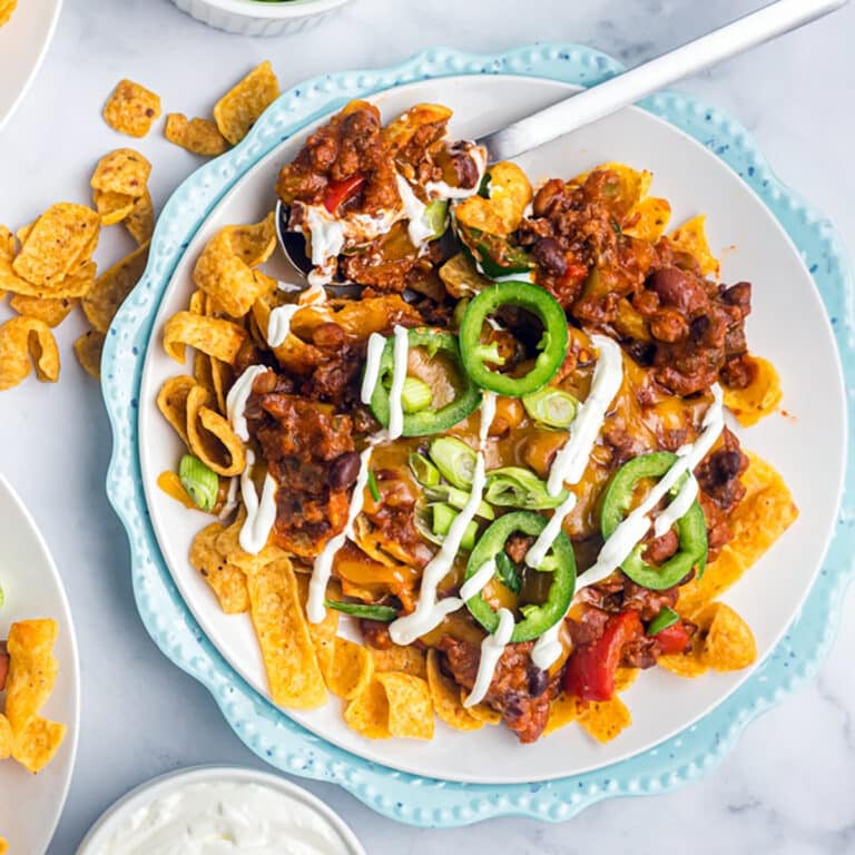 plate of frito pie drizzled with sour cream.