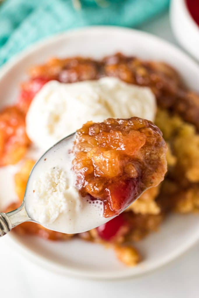 bite of pineapple dump cake & ice cream on a spoon.