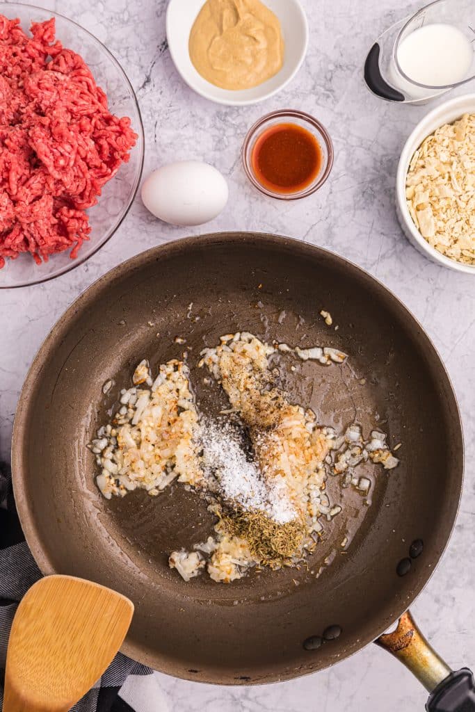 overhead shot of onions sauteing in a pan.