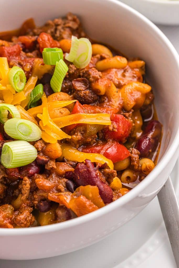 side view of a white bowl of chili mac.