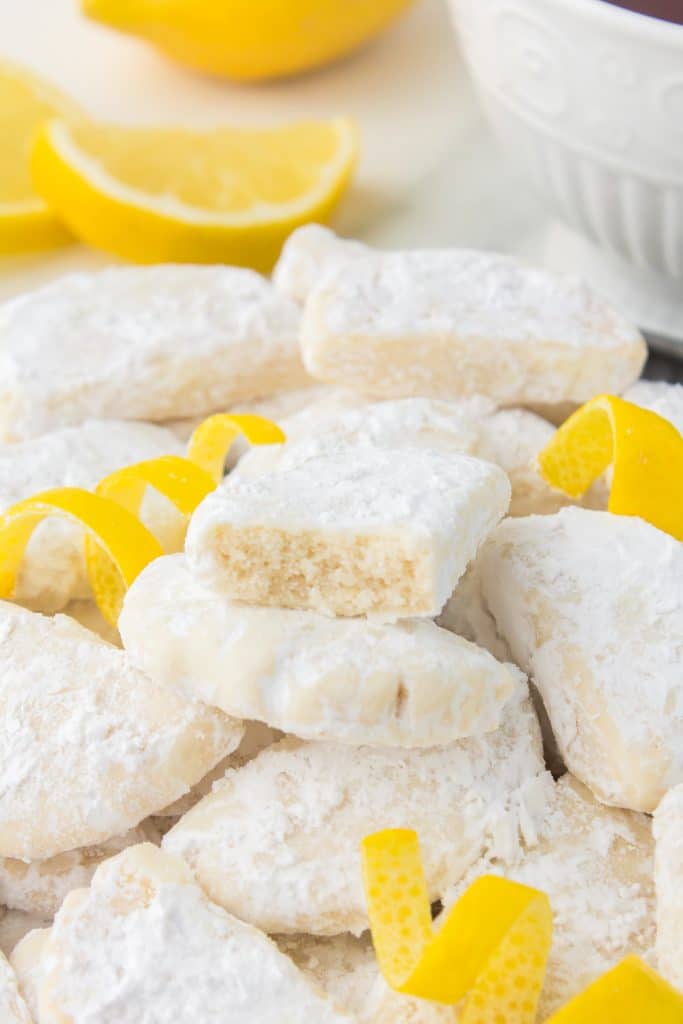 pile of copycat savannah smiles cookies with lemon peels.
