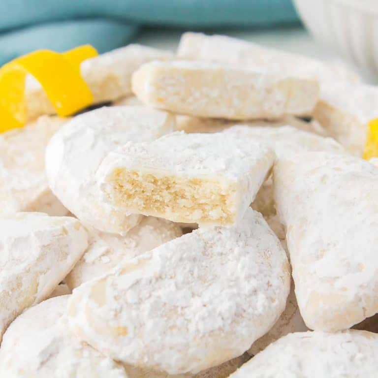 pile of savannah smiles cookies with a bite taken out of one.