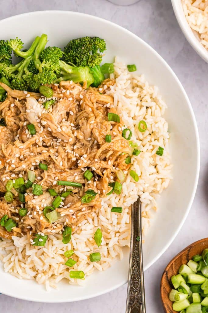 overhead shot of teriyaki chicken on rice with broccoli.
