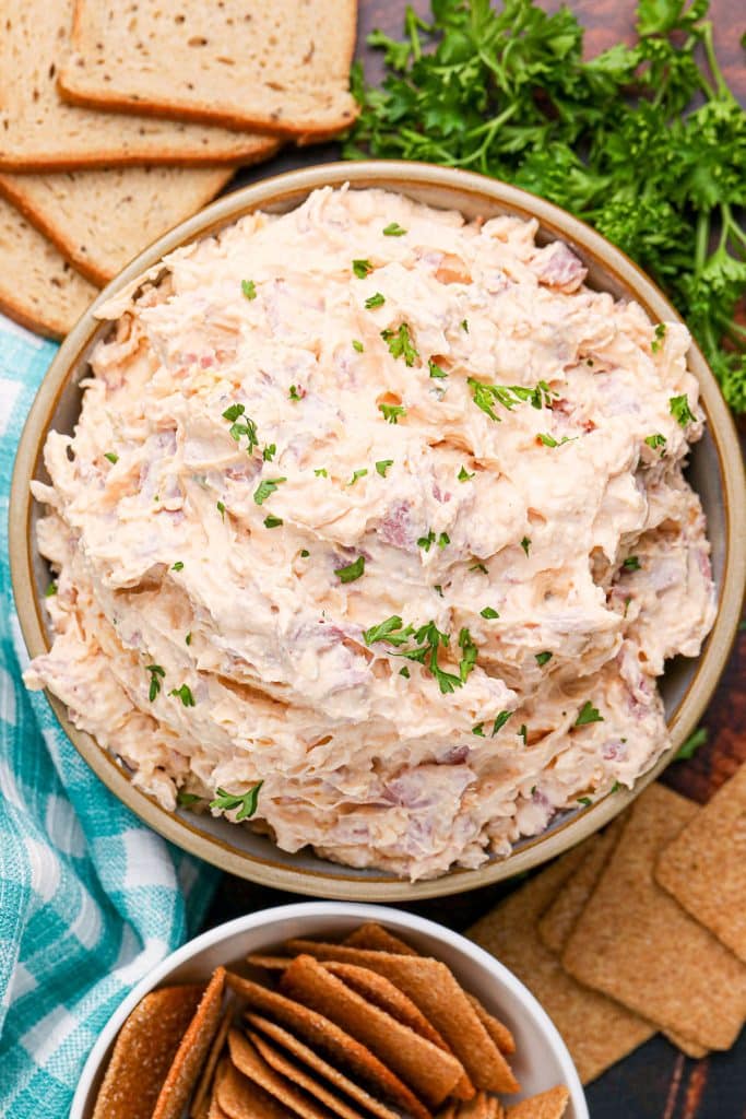 overhead shot of reuben dip in a bowl surrounded by crackers.