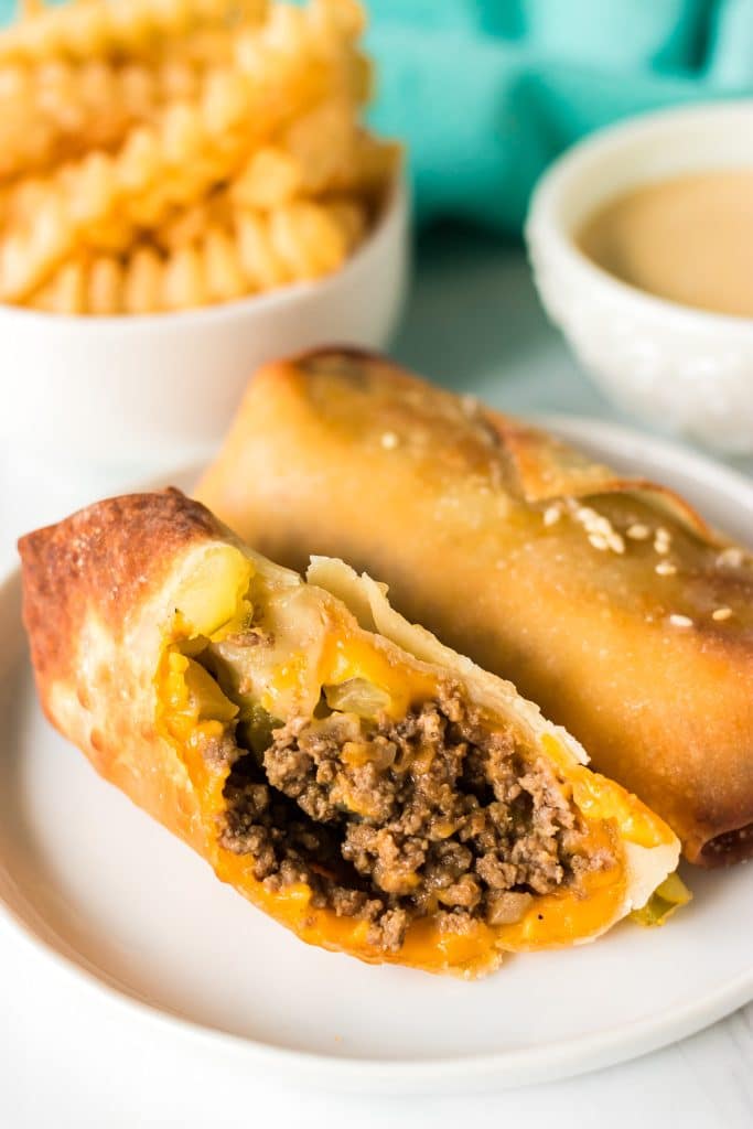 sliced big mac egg roll on a white plate.