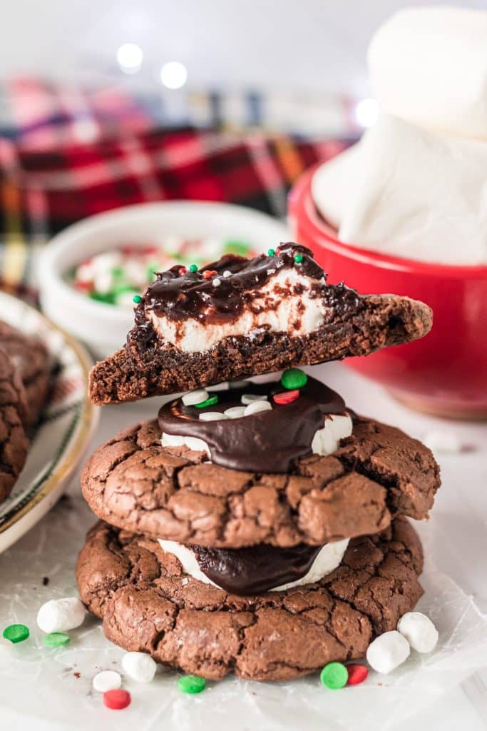 stack of 3 cookies, the top one cut in half showing the marshmallow center.