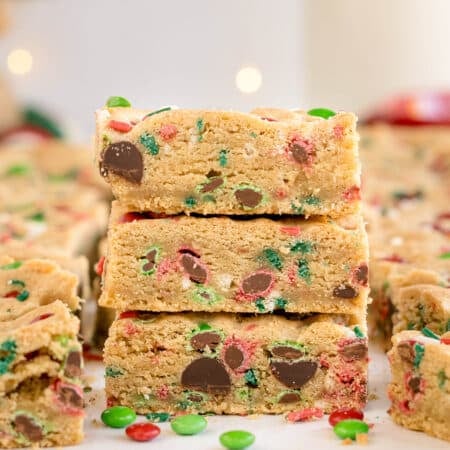 stack of christmas cookie bars with colorful M&Ms and sprinkles.