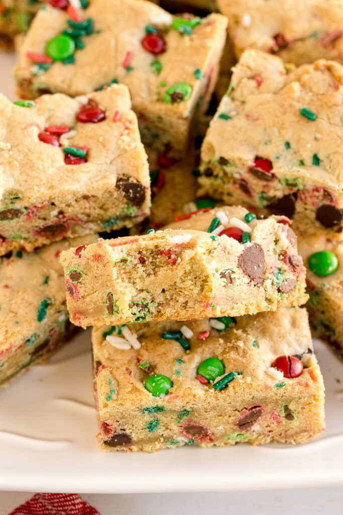 stack of christmas cookie bars with one missing a bite.
