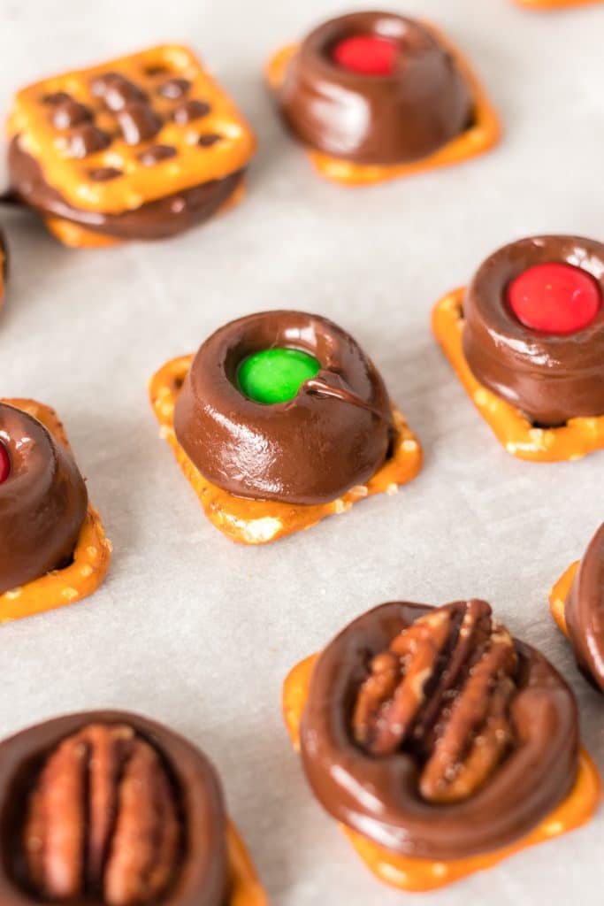rolo pretzels topped with M&M, pecan half, and pretzels.