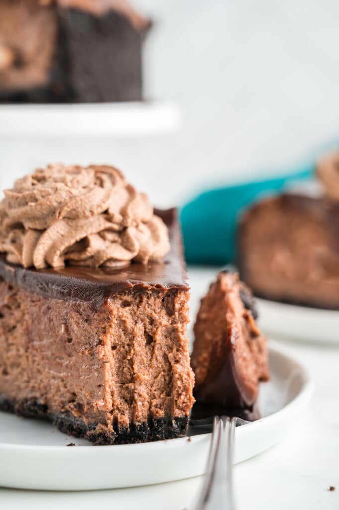 slice of chocolate cheesecake with a bite missing.