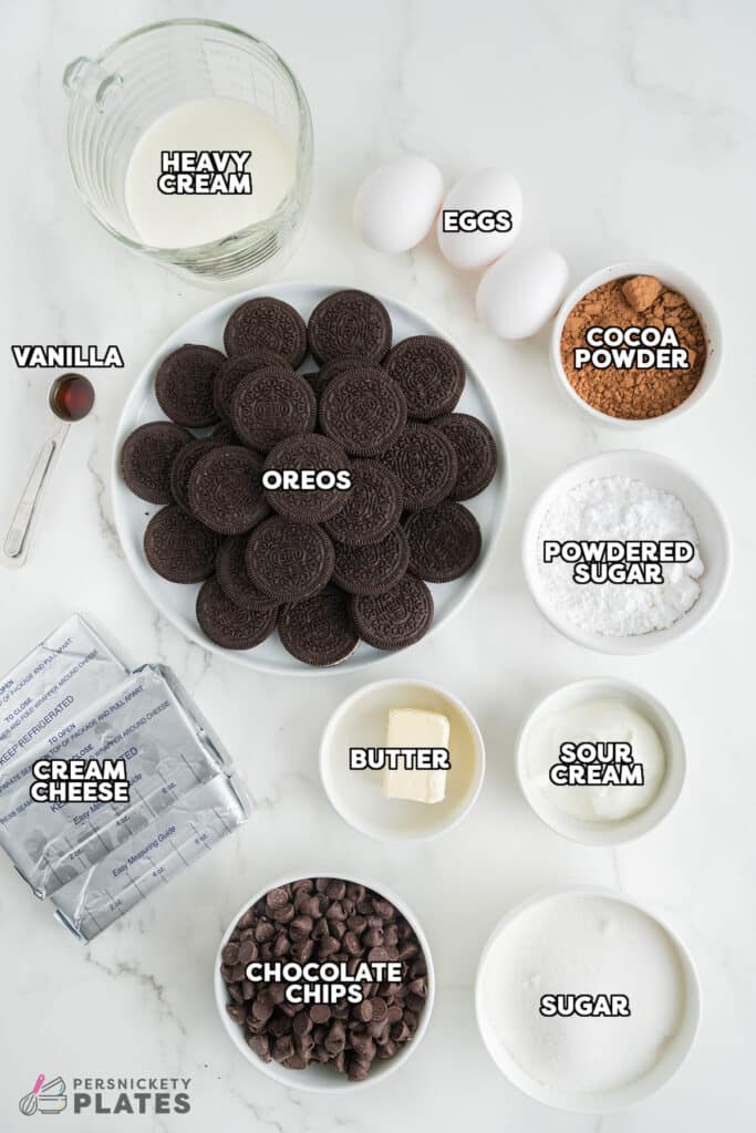 overhead shot of labeled ingredients laid out to make a chocolate cheesecake.