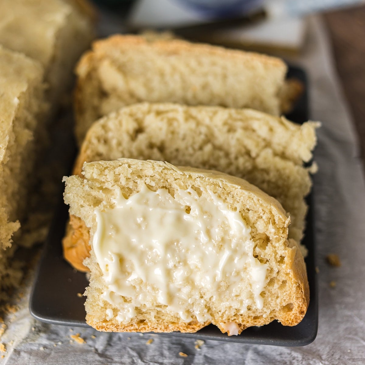slice of buttered bread on a plate.