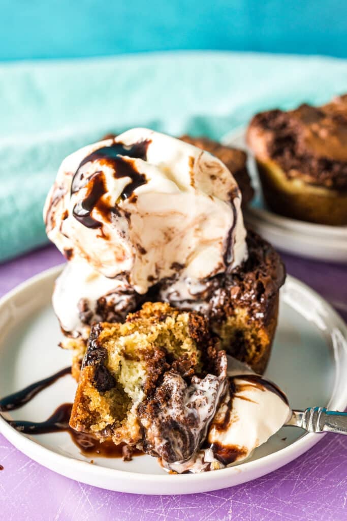 bite of brookie cheesecake cup with ice cream on a fork.