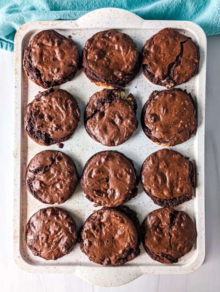 overhead shot of brookie cheesecake cups in a muffin pan.