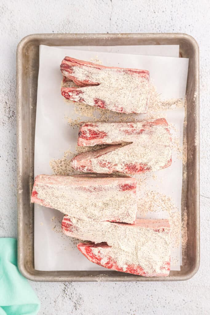 seasoning sprinkled onto short ribs.