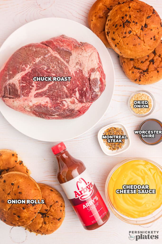 overhead shot of labeled ingredients laid out to make crockpot beef n cheddar sandwiches.