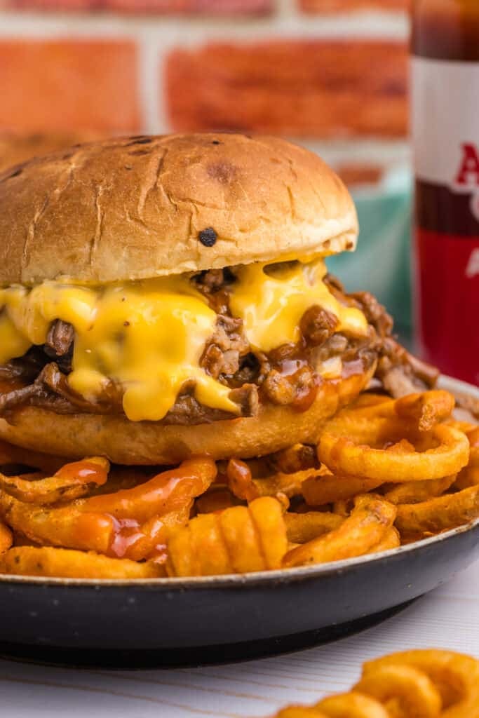 beef & cheddar sandwich with curly fries.