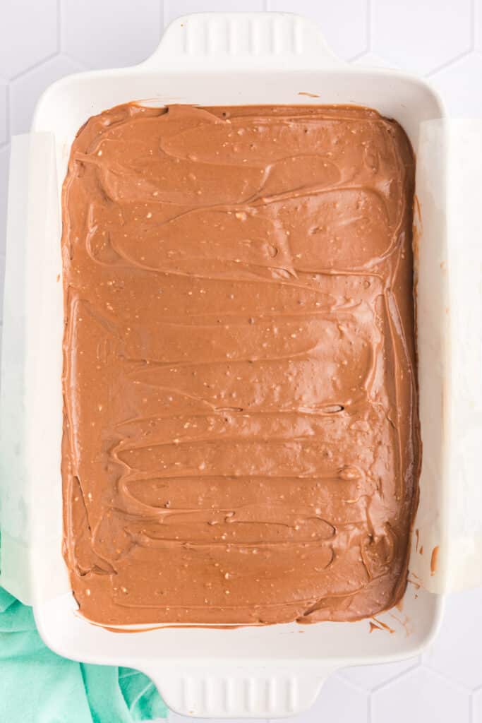 overhead shot of a pudding layer spread into a baking dish.