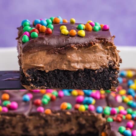 layered cosmic brownie lush being lifted from a pan.