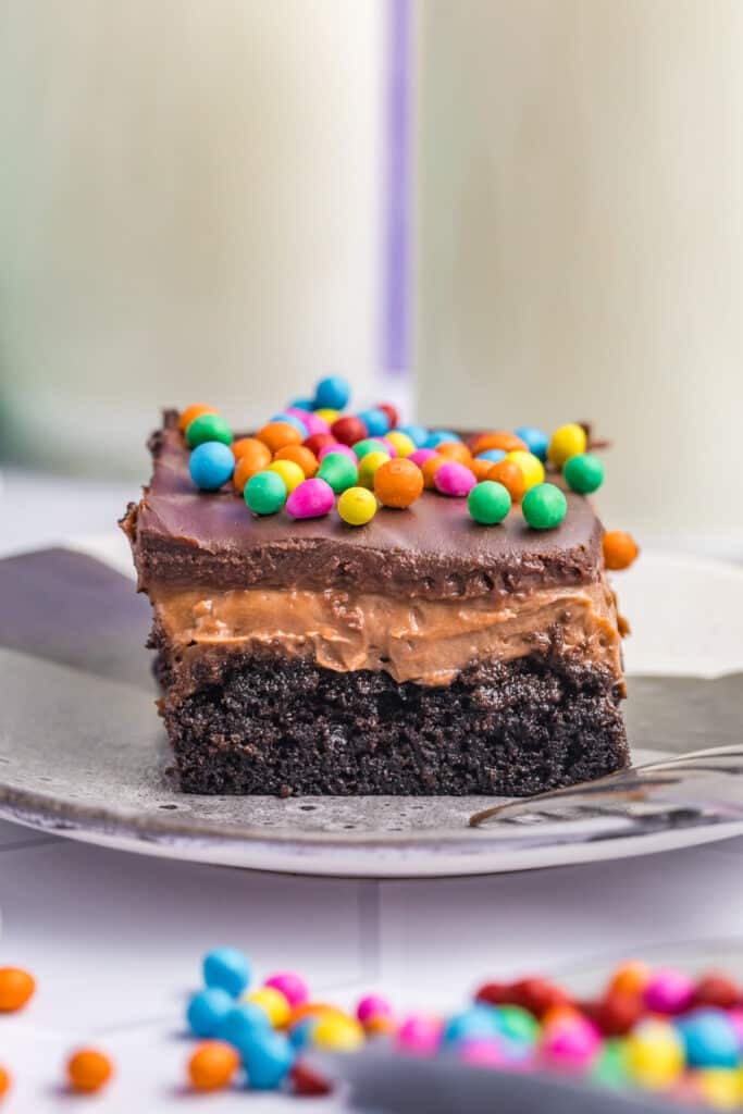 layered cosmic brownie lush on a plate with rainbow sprinkles.