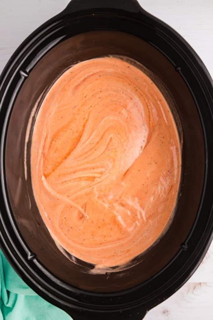 pink sauce in a crockpot.