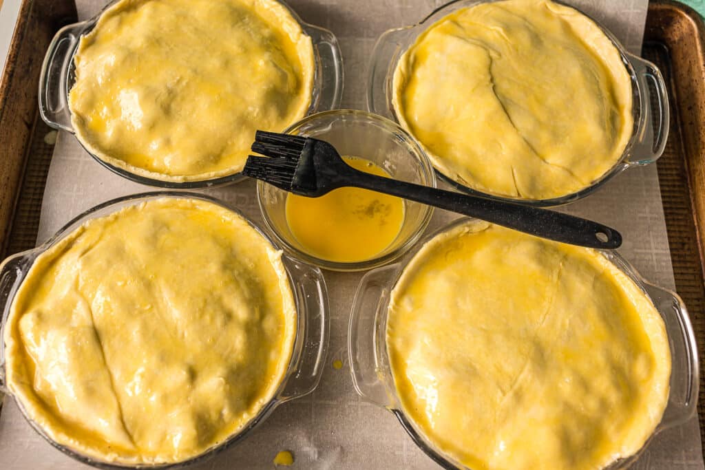 egg wash brushing onto pot pies.