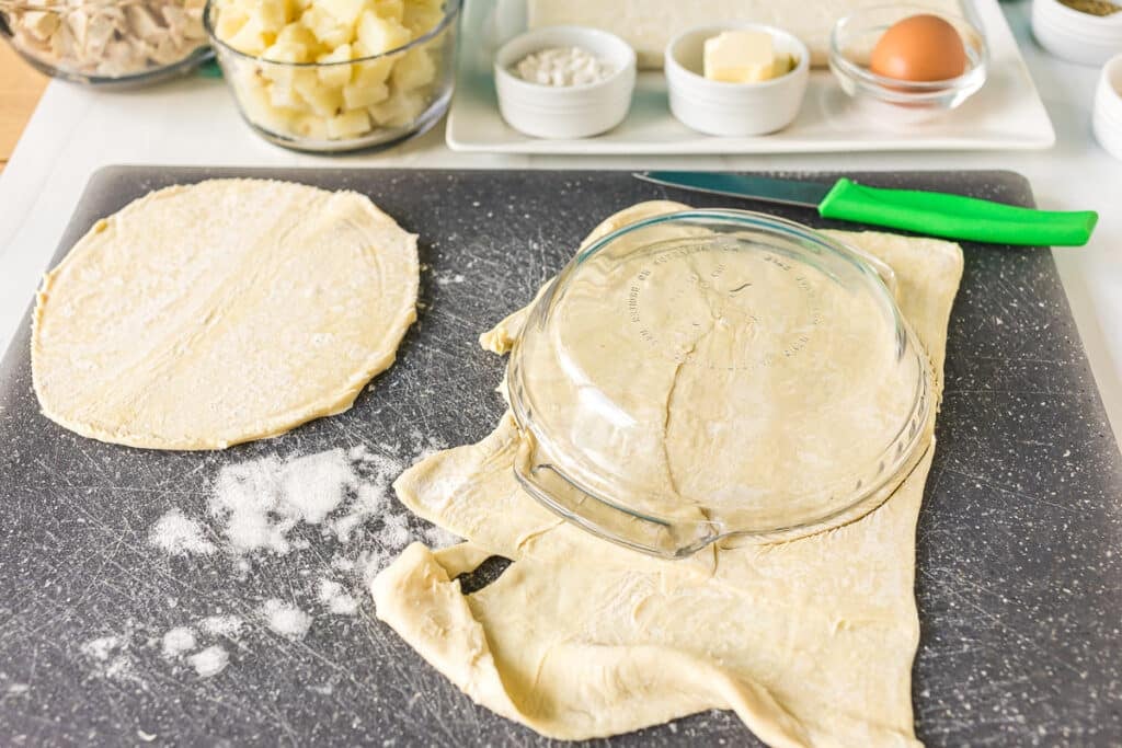 cutting puff pastry with a pie plate.