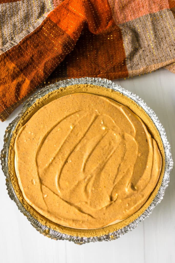 layered pumpkin cheesecake before baking.