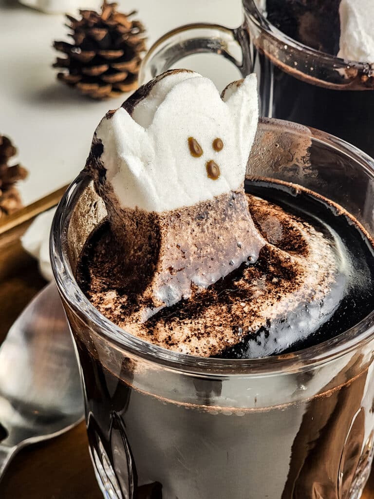 melting ghost marshmallow in a mug of hot chocolate.