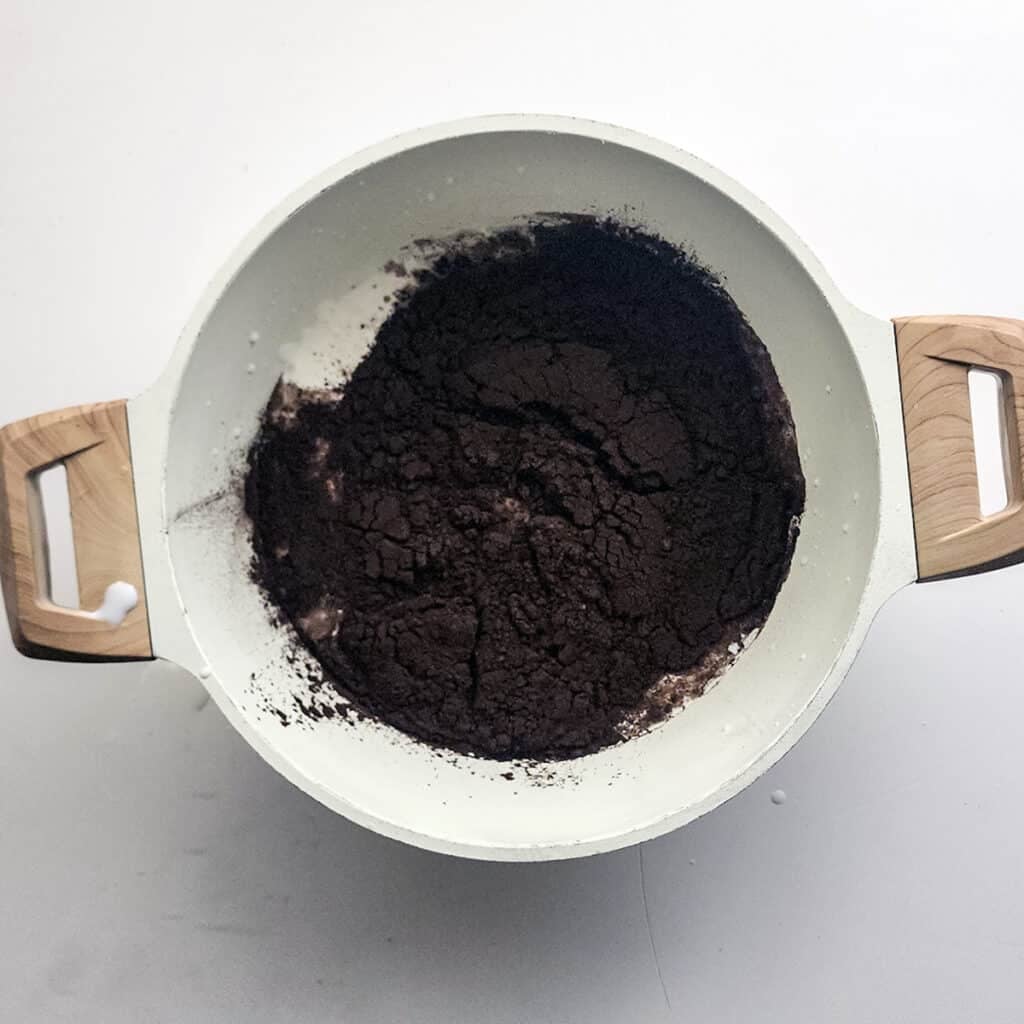overhead shot of black cocoa powder in a pot.