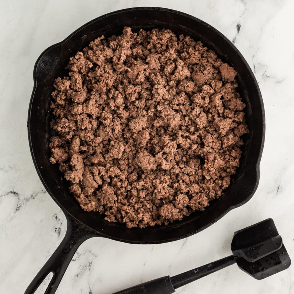 overhead shot of browned ground beef in a skillet.
