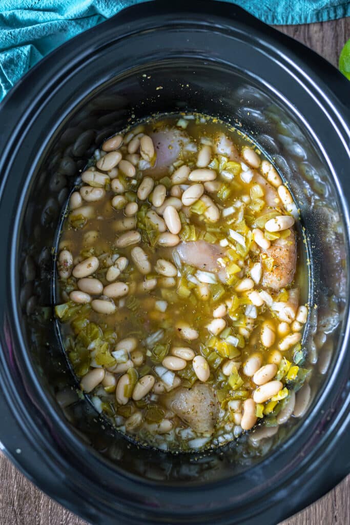 overhead shot of beans and broth in a crockpot.
