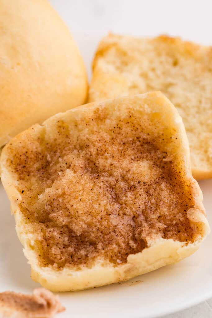 texas roadhouse roll with cinnamon honey butter spread on it.