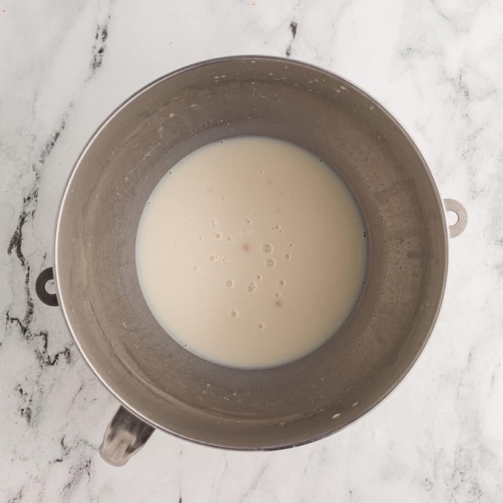overhead shot of yeast blooming in a mixing bowl.