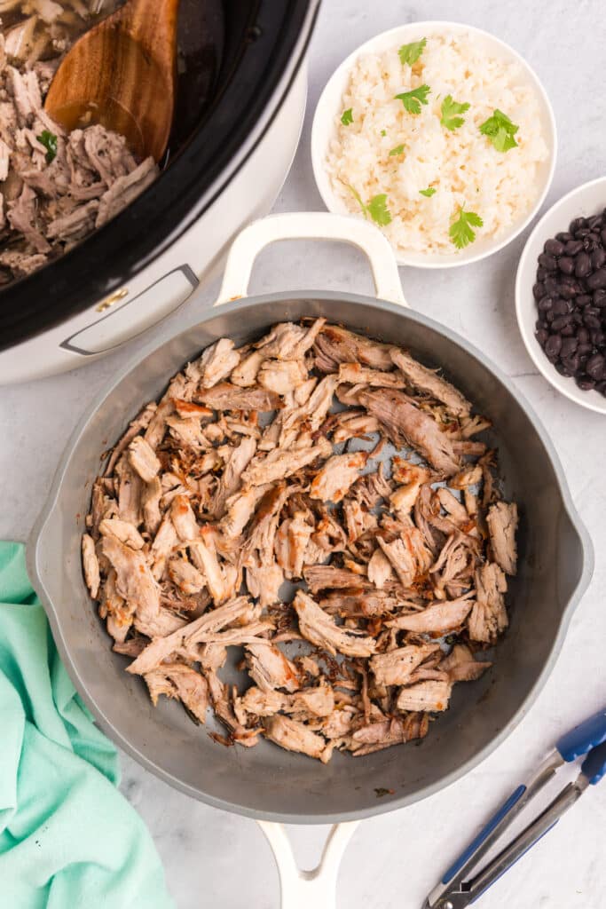 overhead shot of shredded pork in a skillet.