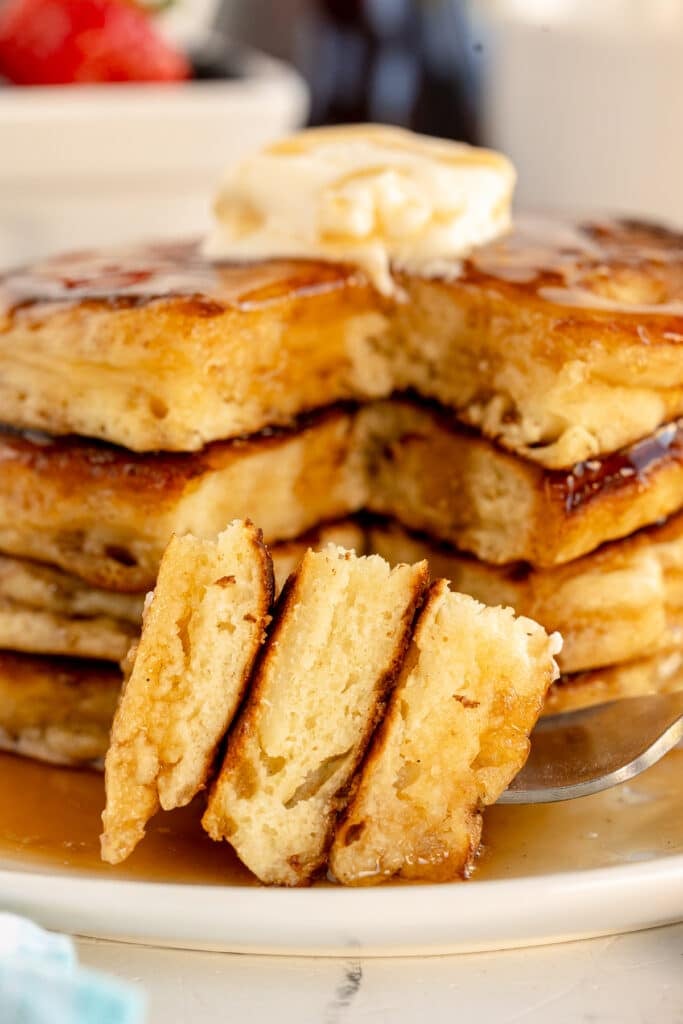 fork with a bite of pancakes.