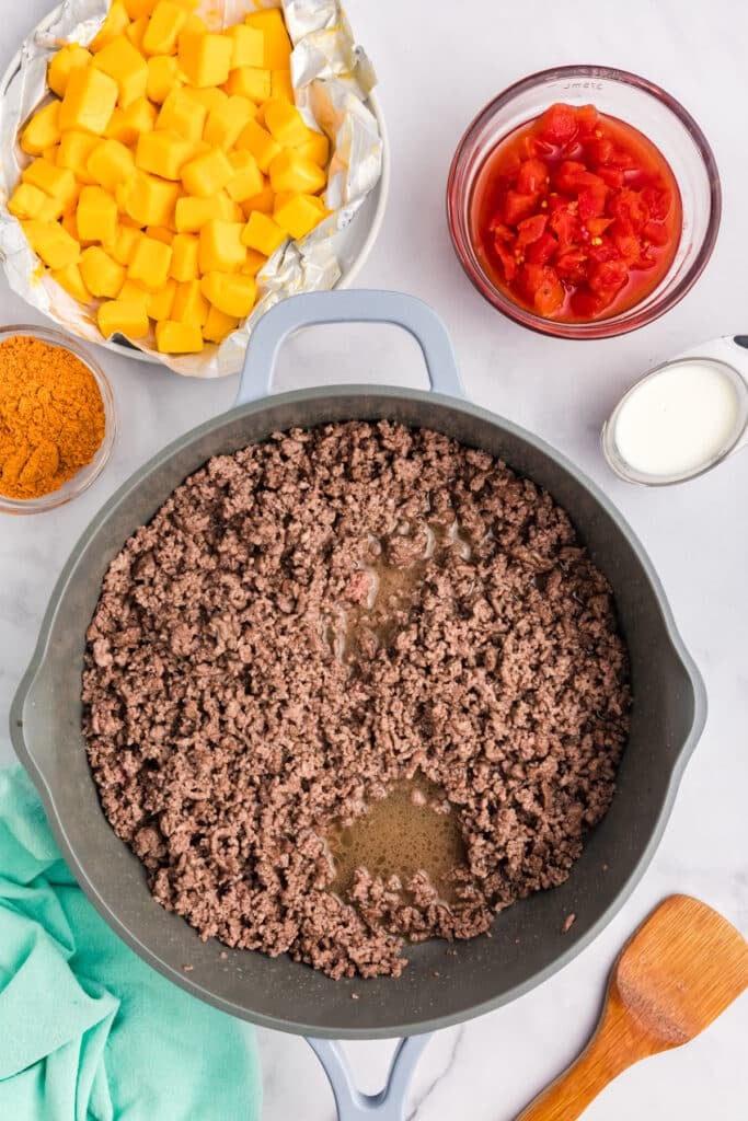 overhead shot of browned ground beef in a skillet.