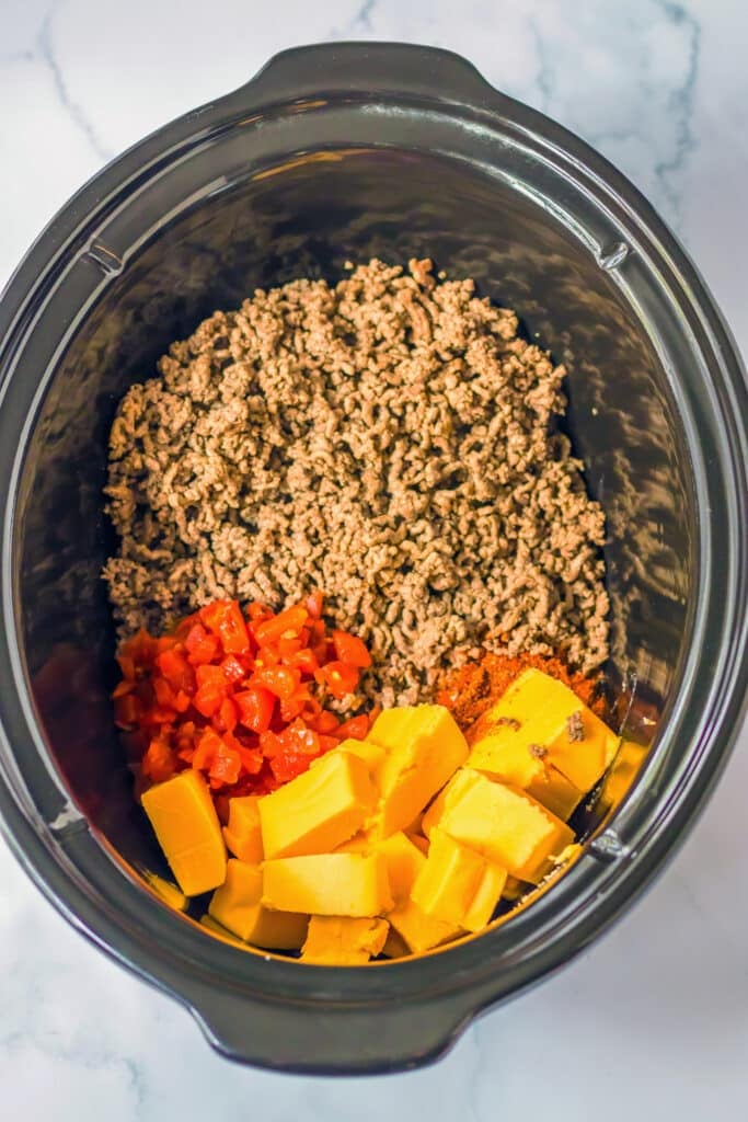 ground beef, rotel, and cubed velveeta in a crockpot.